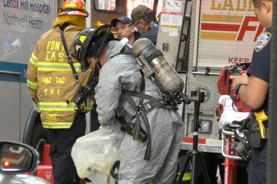 A firefighter in a hazmat suit on 61st Street this morning